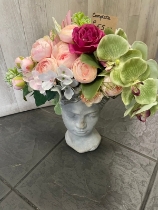 Stone effect head planter complete with a complimenting silk flower display